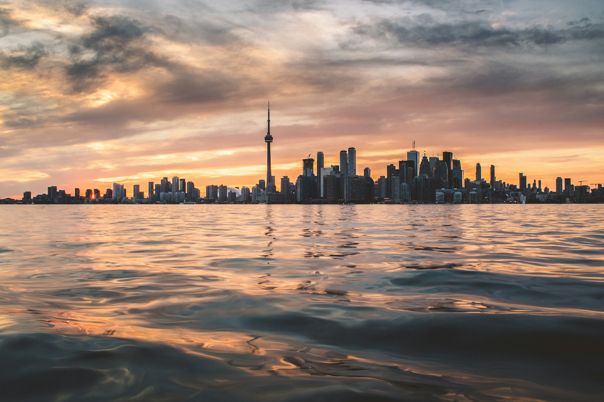 Lake Ontario at golden hour with the Toronto skyline across the water